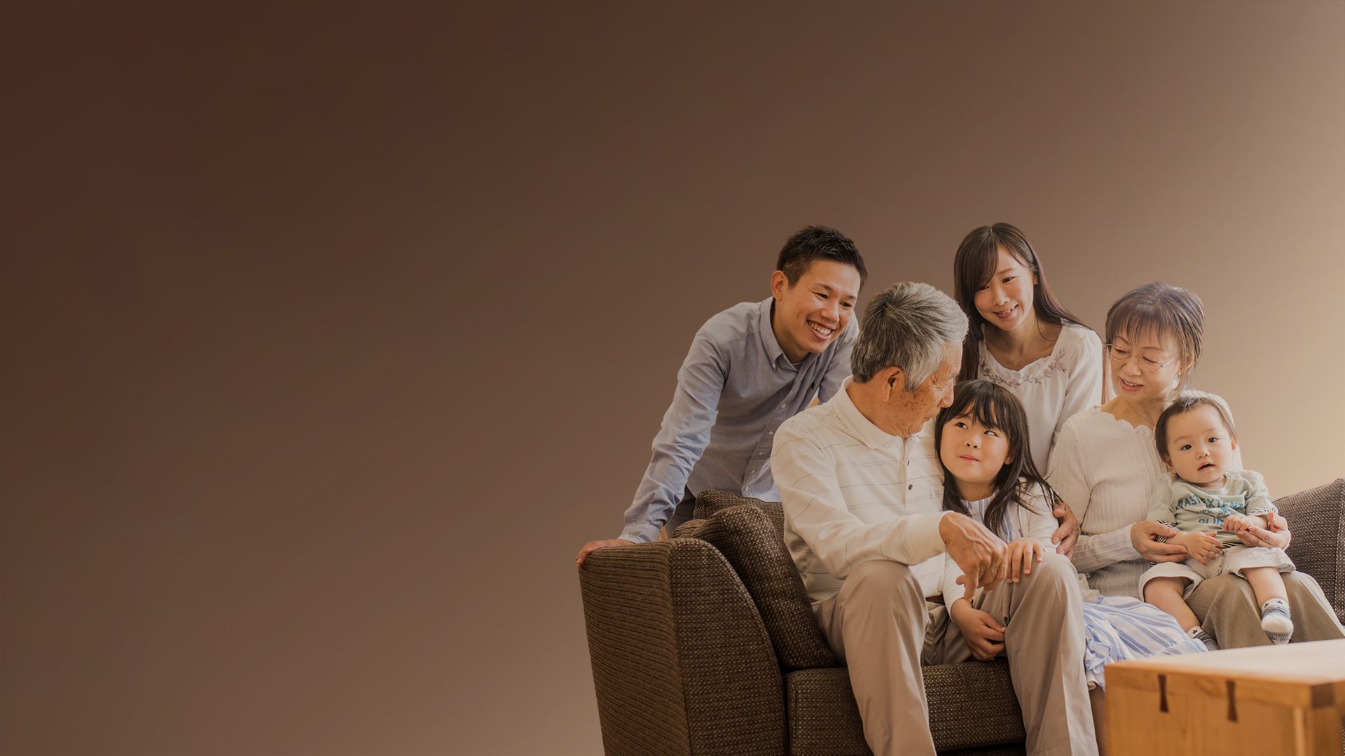 Three generations of a family together on a sofa